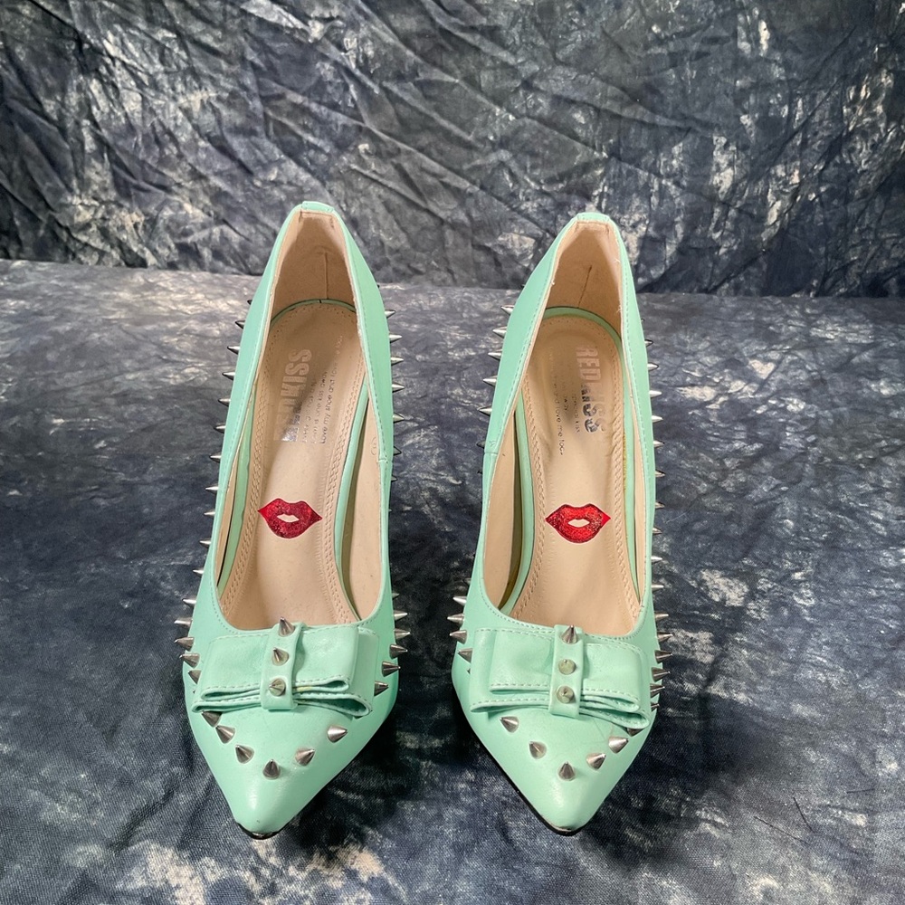 Red Kiss green heels with spikes.